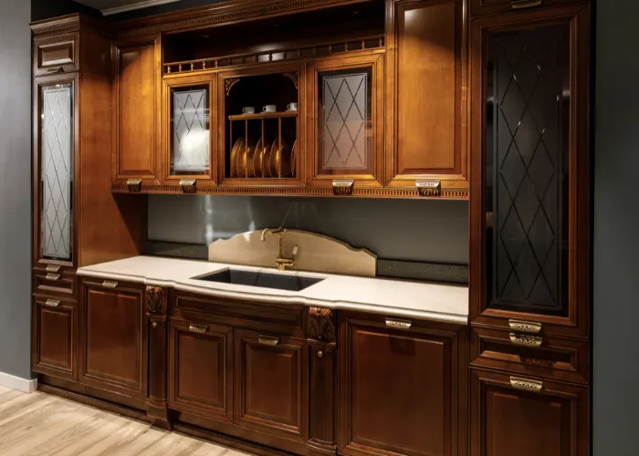 Beautiful real wood kitchen cabinets, with inset lights shining on the countertop